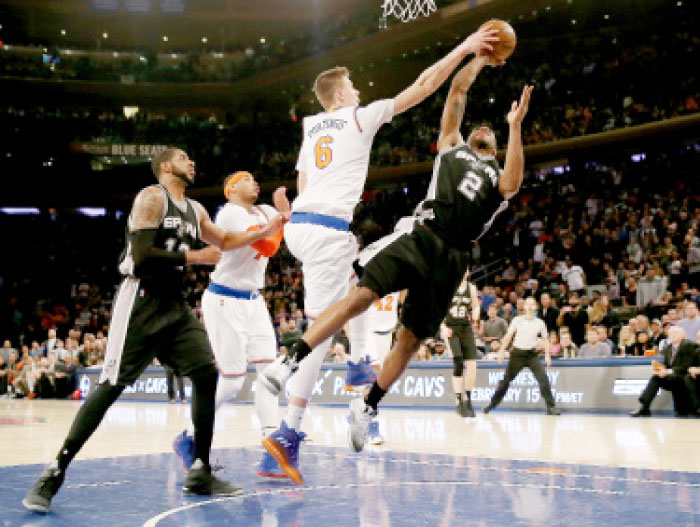 Kristaps Porzingis No. 6 of the New York Knicks blocks a shot by Kawhi Leonard No. 2 of the San Antonio Spurs in the fourth quarter at Madison Square Garden on Sunday in New York City. — AFP
