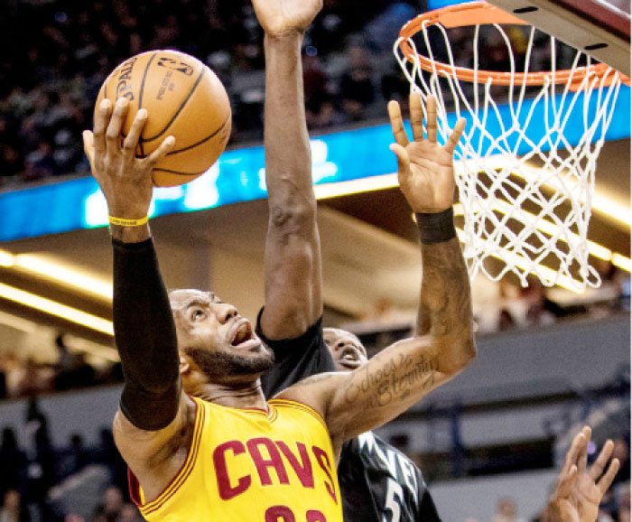 Cleveland Cavaliers’ LeBron James shoots over Minnesota Timberwolves’ Gorgui Dieng during their NBA game at Target Center in Minneapolis Tuesday. — Reuters