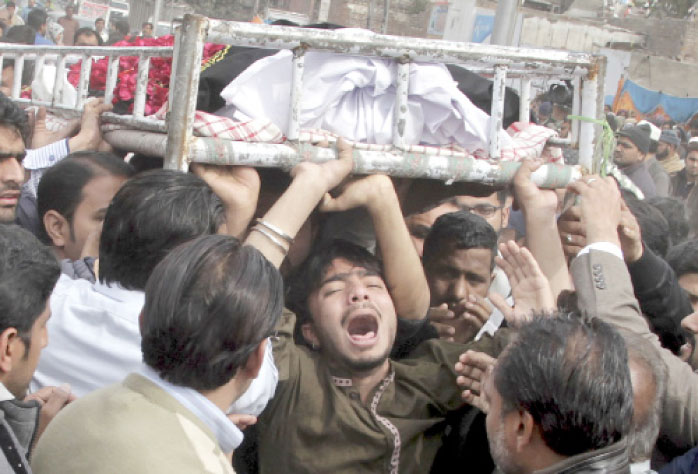 People mourn the death of a family member who was killed in a deadly Monday bomb blast, during a funeral in Lahore, on Tuesday. — AP