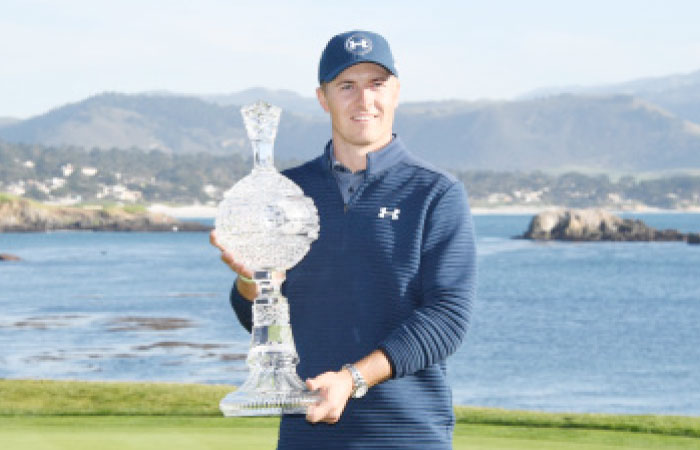 Jordan Spieth poses with the trophy on the 18th green during the final round of the AT&T Pebble Beach Pro-Am golf tournament at Pebble Beach Golf Links. — Reuters