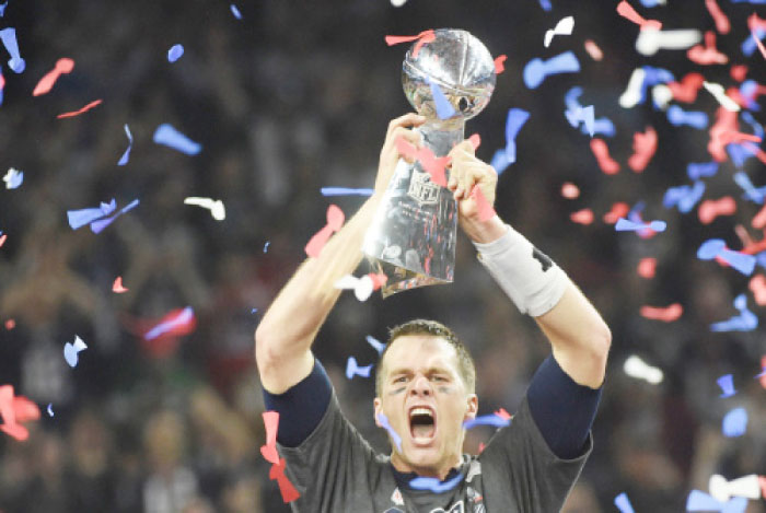 Tom Brady No. 12 of the New England Patriots holds the Vince Lombardi Trophy after defeating the Atlanta Falcons 34-28 in overtime during Super Bowl 51 at NRG Stadium on Sunday in Houston, Texas. The Patriots defeated the Falcons 34-28 after overtime. — AFP