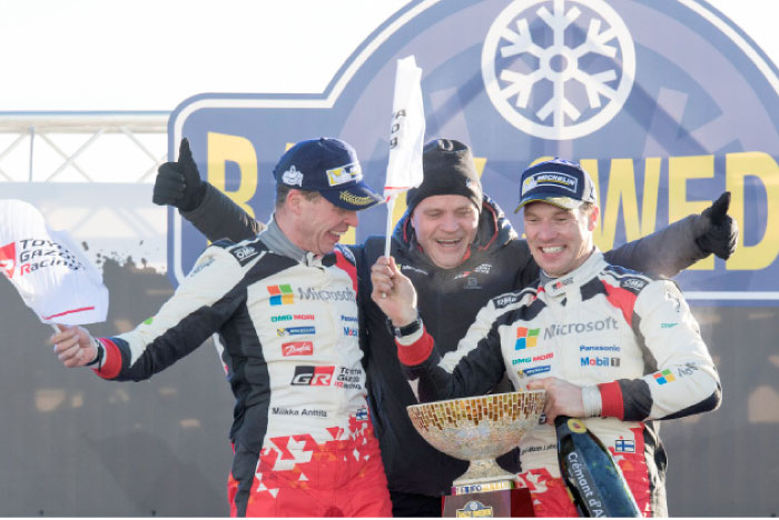 Finland’s Jari-Matti Latvala, co-driver Miikka Anttila, and team manager Tommi Makinen celebrate after winning the Rally Sweden in Torsby. — Reuters