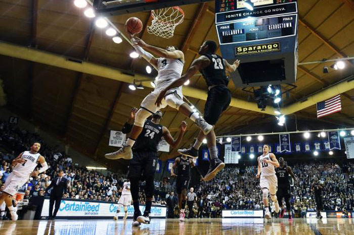 Josh Hart of the Villanova Wildcats lays up a shot against Marcus Derrickson and Rodney Pryor of the Georgetown Hoyas at The Pavilion  Wednesday in Villanova, Pennsylvania. — AFP