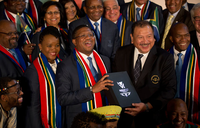 This file photo of South Africa's Minister of Sport and Recreation Fikile Mbalula, center, holds candidate city Durban's 2022 Commonwealth Games bid book with President of the Commonwealth Games Federation Malaysia's Prince Imran, center right, in London, on March 2, 2015.  — AP