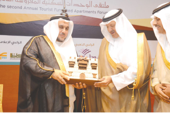 Prince Sultan Bin Salman, president of the Saudi Commission for Tourism and National Heritage, receives a memento from Hassan Dahlan, Secretary General of the Jeddah Chamber of Commerce and Industry