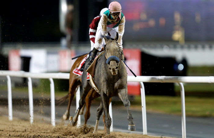 Mike Smith rides Arrogate to the finish line to win the ninth and final race of the Dubai World Cup at Meydan Racecourse Saturday. — Reuters