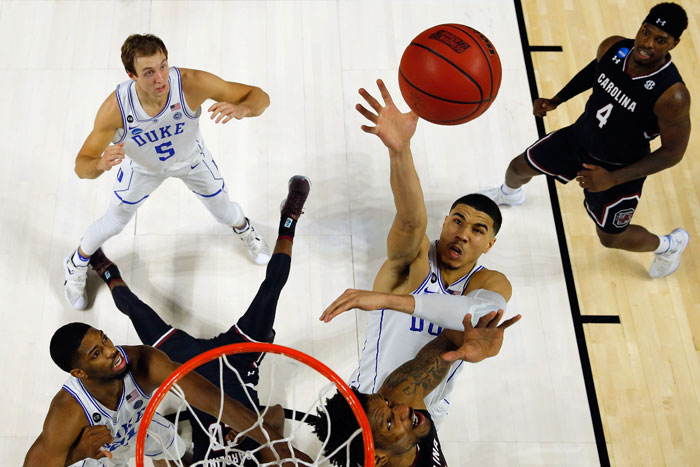 Jayson Tatum No. 0 of the Duke Blue Devils battles for the ball against the South Carolina Gamecocks during the second round of the 2017 NCAA Men's Basketball Tournament at Bon Secours Wellness Arena on Sunday in Greenville, South Carolina. — AFP