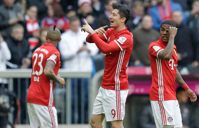 Bayern's Robert Lewandowski celebrates after scoring his side's third goal during the German Bundesliga soccer match against Eintracht Frankfurt at the Allianz Arena Stadium in Munich Saturday. — AP