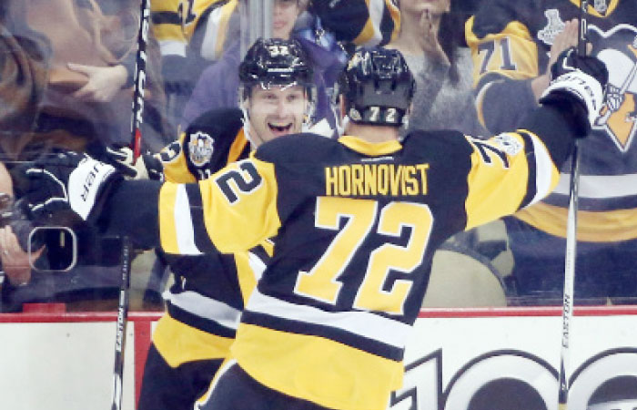 Pittsburgh Penguins’ defenseman Mark Streit (L) celebrates his goal with Patric Hornqvist against the Tampa Bay Lightning during their NHL game at the PPG Paints Arena in Pittsburgh Friday. — Reuters