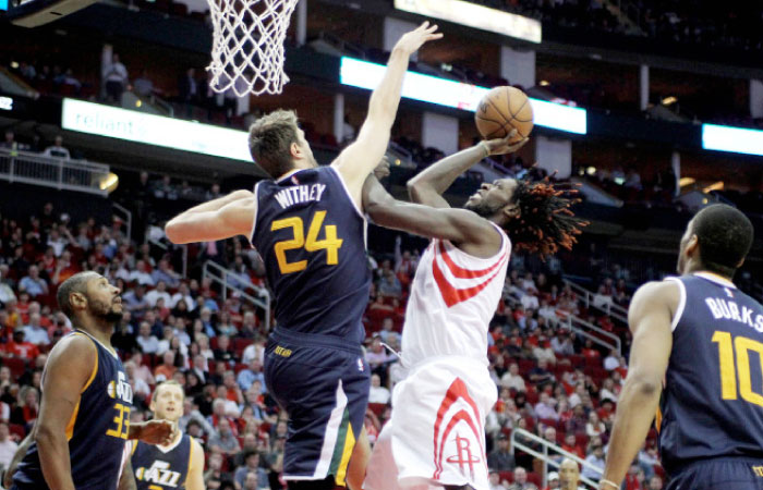 Houston Rockets’ forward Montrezl Harrell puts up an inside shot while Utah Jazz’s center Jeff Withey defends during their NBA game at Toyota Center in Houston Wednesday. — Reuters