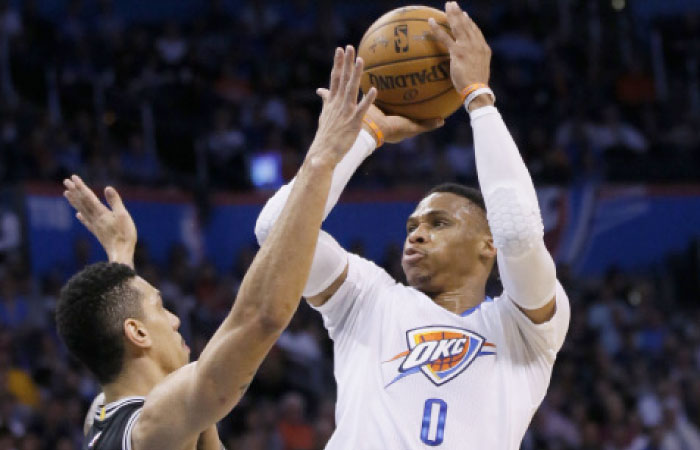 Oklahoma City Thunder’s guard Russell Westbrook shoots in front of San Antonio Spurs’ guard Danny Green during their NBA game in Oklahoma City, Thursday. — AP