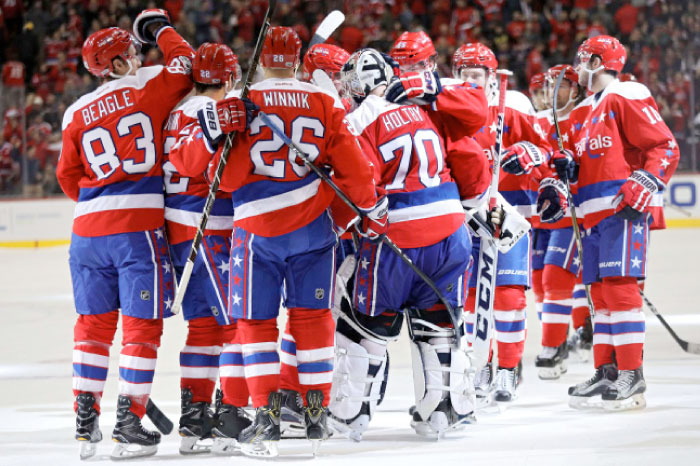 Washington Capitals players celebrate after defeating Columbus Blue Jackets in their NHL game at Verizon Center in Washington Thursday. — Reuters