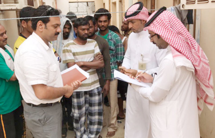 Saudi Labor Ministry officials visit the aggrieved workers in their new accommodation on Wednesday with P.V. Abdul Jalil, an Indian community worker. — SG photo
