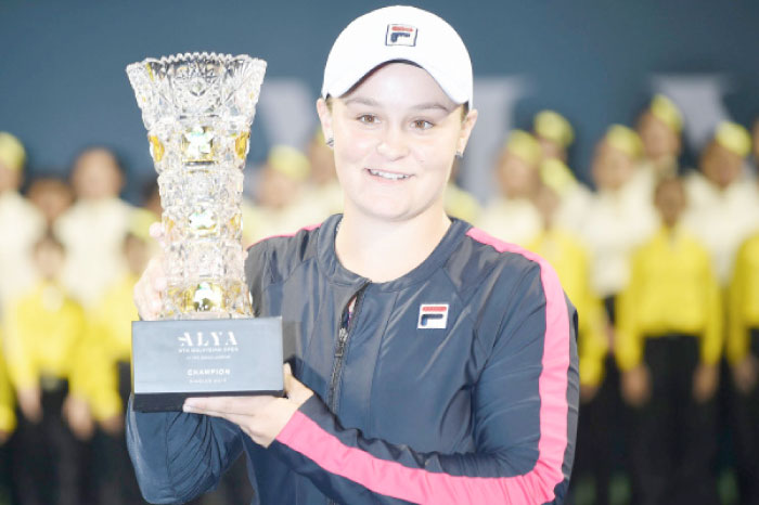 Ashleigh Barty of Australia poses with her trophy after winning against Japan’s Nao Hibino in their women’s singles finals match of the WTA Malaysian Open tennis tournament in Kuala Lumpur. — AFP