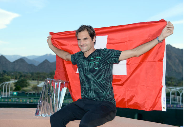 Roger Federer of Switzerland along with his BNP Paribas Open trophy poses for photographers after defeating Stan Wawrinka of Switzerland during the men’s final of the BNP Paribas Open at the Indian Wells Tennis Garden on Sunday in Indian Wells, California. — AFP