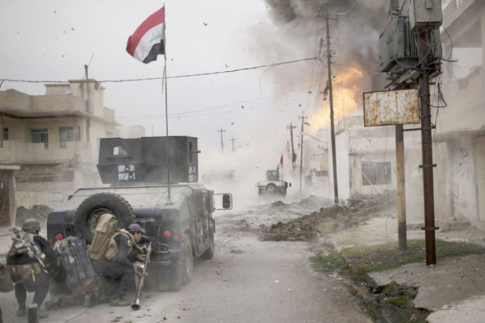 In this file photo, a car bomb explodes next to Iraqi special forces armored vehicles as they advance toward Daesh held territory in Mosul. — AP