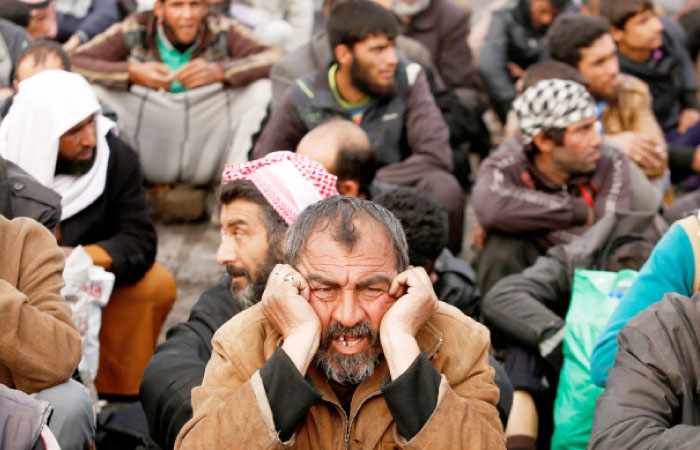 Displaced Iraqis who had fled their homes stop for a check by Iraqi forces, as Iraqi forces battle with Daesh militants, in western Mosul. — Reuters