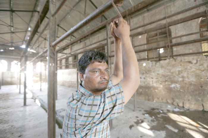 Mehta, 40, stands at a slaughter house where he used to work after it was shutdown by authorities in Allahabad, India, on Sunday. — AP