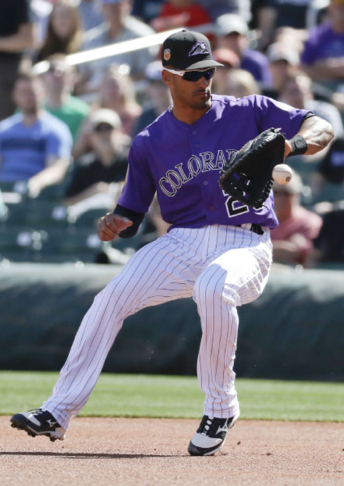 This file photo shows Colorado Rockies first baseman Ian Desmond fielding a ball during first inning at a spring baseball game in Scottsdale, Ariz. Colorado Rockies first baseman Ian Desmond will undergo surgery Wednesday. — AP