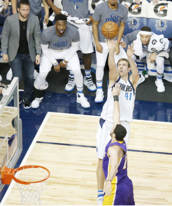 Los Angeles Lakers’ forward Larry Nance Jr. (7) defends Dallas Mavericks’ forward Dirk Nowitzki as he shoots during their NBA game in Dallas Tuesday. — AP