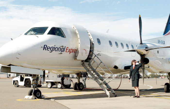 Captain Belinda Fleming stands in front of a Regional Express Airlines (REX) plane during the airline’s launch at Sydney Airport in this Aug. 6, 2002 file photo. — AFP