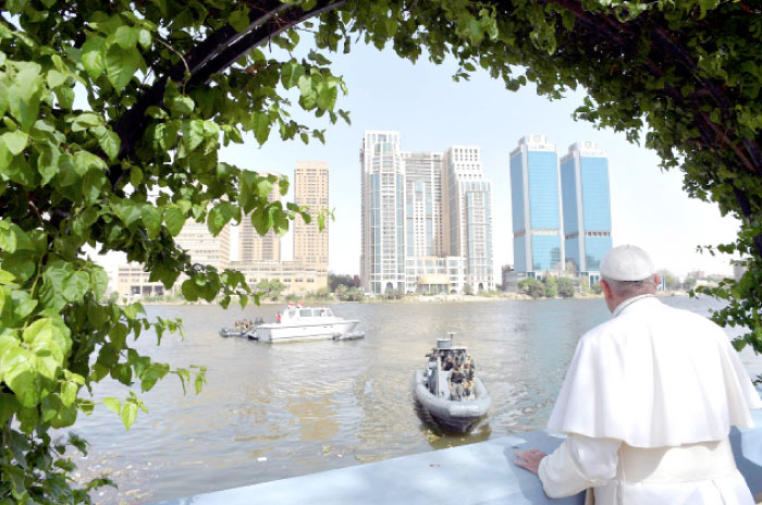 Pope Francis looks over the river Nile from a terrace in Cairo on Saturday. — Reuters