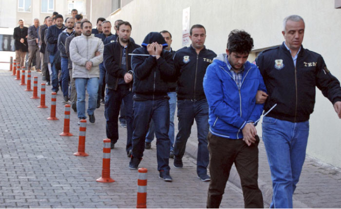 Police officers escort people, arrested because of suspected links to US-based cleric Fethullah Gulen, in Kayseri, Turkey, Wednesday. — AP