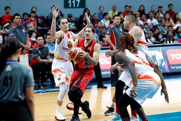 San Miguel Beer's Marcio Lassiter is hounded by Phoenix's (from L) JC Intal, Norbert Torres and Jameel McKay in their PBA Commissioner's Cup game at the Mall of Asia Arena Friday night.