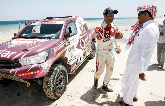 Nasser Saleh Al-Attiyah of Qatar celebrates victory with QMMF President Abdulrahman Al-Mannai.