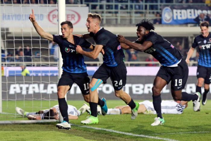Atalanta’s Remo Freuler (L) celebrates with his teammates Andrea Conti (C) and Franck Kessie after scoring during a Serie A match against Juventus in Bergamo, Italy, Friday. — AP