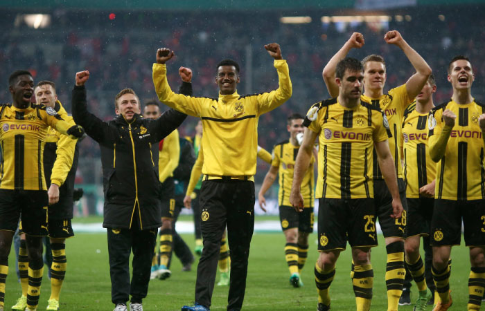 Borussia Dortmund players celebrate after beating Bayern Munich Wednesday. — Reuters