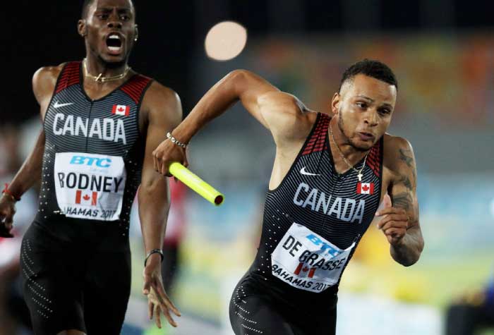 Brendon Rodney hands the baton to Andre De Grasse of Canada in the Men's 4x200 Metres Relay Final during the IAAF/BTC World Relays Bahamas 2017 at Thomas Robinson Stadium on Sunday in Nassau, Bahamas. — AFP