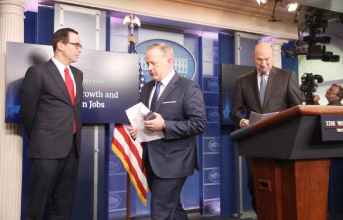 White House press secretary Sean Spicer yields the podium to National Economic Director Gary Cohn, right, and Treasury Secretary Steve Mnuchin in the briefing room of the White House in Washington, Wednesday, where they discussed President Donald Trump tax proposals. — AP
