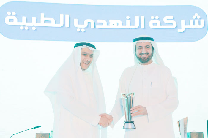 Minister of Health Dr. Tawfiq Al-Rabiah delivers an awareness award to the CEO of Al Nahdi. — Courtesy photo