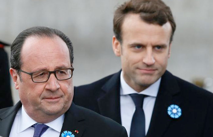 Outgoing French President Francois Hollande (L) stands by President-elect Emmanuel Macron (R) as they attend a ceremony marking the 72nd anniversary of the victory over Nazi Germany during World War II on May 8, 2017 in Paris. — AFP