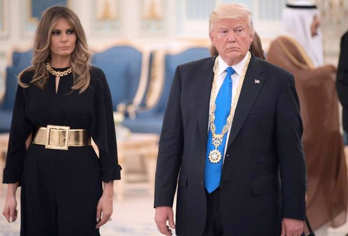 US President Donald Trump and First Lady Melania Trump make their way to a luncheon after Trump received the Order of Abdulaziz al-Saud medal from Saudi Arabia's King Salman bin Abdulaziz al-Saud at the Saudi Royal Court in Riyadh on May 20, 2017. — AFP