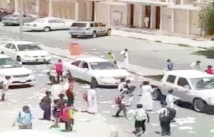 A video that went viral on social media shows children of a Tabuk school tearing up textbooks and throwing them on pedestrians. — Okaz photo