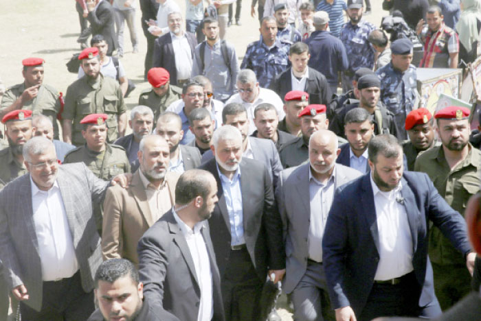 Ismail Haniyeh, new Hamas leader, centre, surrounded by Palestinian security officers, leaves a solidarity tent for hunger-striking Palestinian prisoners held by Israel, at the main square in Gaza City. — AP