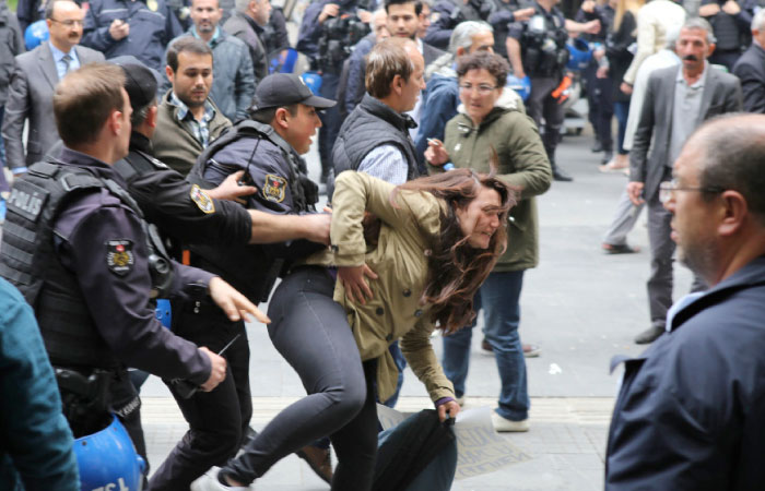 Turkish riot police detain a protester during a demonstration against the arrest of hunger strikers Nuriye Gulmen and Semih Ozakca, in Ankara. — AFP