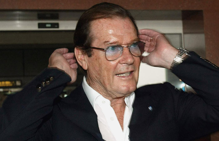 This file photo shows former James Bond actor Sir Roger Moore combs his hair as he arrives at Hanoi's airport as a goodwill ambassador for the United Nations Children's Funds (UNICEF). British actor Roger Moore, who played the superspy James Bond over two decades with a suave wit, died Tuesday, aged 89, his children announced. — AFP
