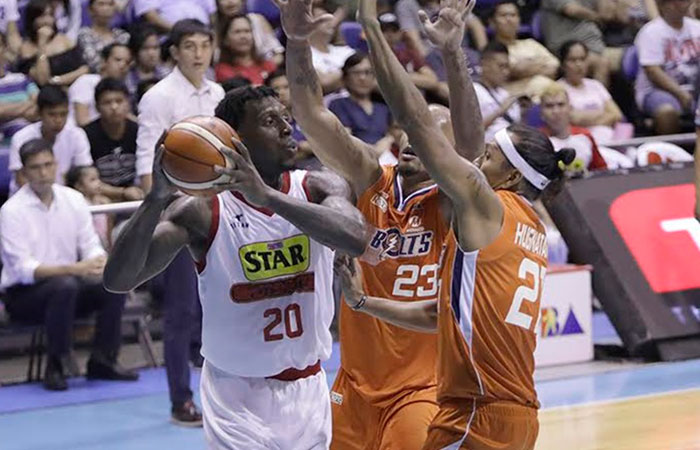 Star's Ricardo Ratliffe gets double-teamed by Meralco's Kelly Nabong (C) and Reynel Hugnatan in their PBA Commissioner's Cup game at the Smart-Araneta Coliseum Wednesday night.