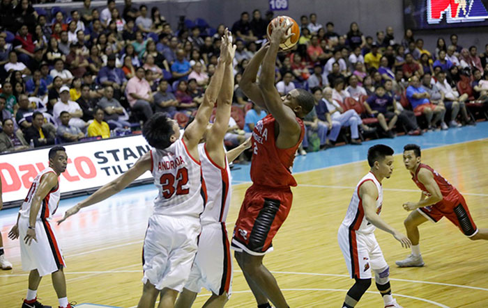 Ginebra's Justin Brownlee fires a shot off two Alaska defenders in their PBA Commissioner's Cup game at the Smart-Araneta Coliseum Sunday night.