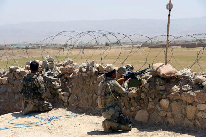 Afghan Border Police personnel keep watch during an ongoing battle between Pakistani and Afghan Border forces near the Durand line at Spin Boldak, in southern Kandahar province, in this May 5, 2017 file photo. — AFP