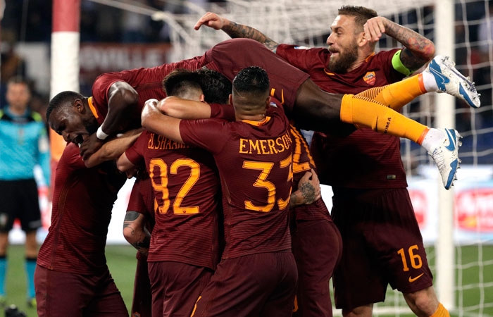 Roma players celebrate after Radja Nainggolan scored his side's third goal, during a Serie A soccer match between Roma and Juventus, at Rome's Olympic stadium on Sunday. Roma won 3-1. — AP