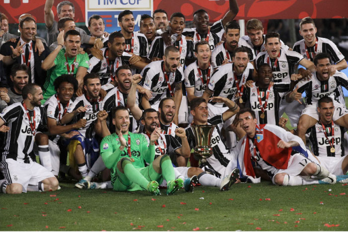 Juventus team celebrates with the trophy after winning the Italian Cup soccer final against Lazio at Rome’s Olympic Stadium Wednesday. — AP