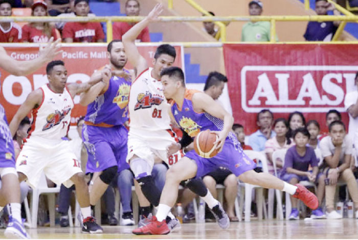 TNT’s RR Pogoy is hounded by Alaska’s Kevin Racal in their PBA Commissioner’s Cup road game in Legazpi City Saturday.