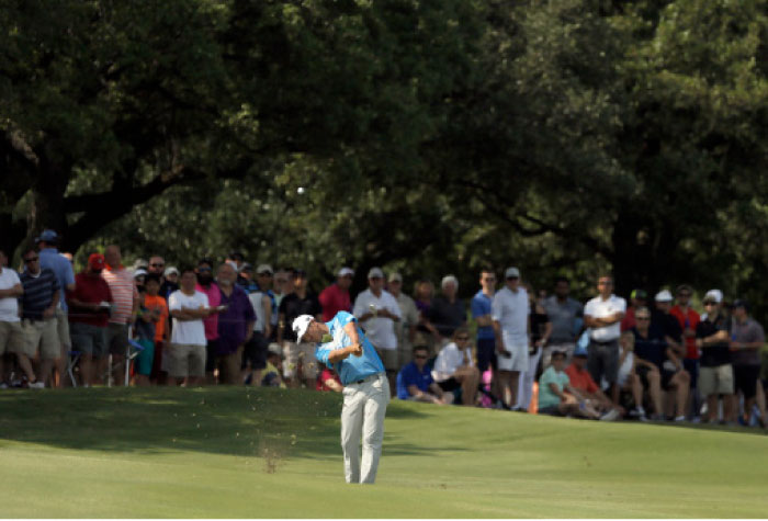 James Hahn hits off the fairway on his approach to the 18th green at the Byron Nelson Golf Tournament in Irving Saturday. — AP