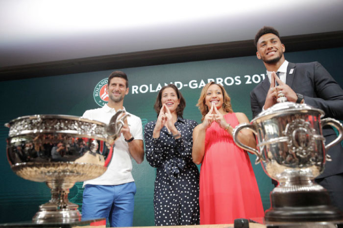 Defending champions Serbia’s Novak Djokovic, Spain’s Garbine Muguruza, French boxer Estelle Mossely (2nd R) and French boxer Tony Yoka (R) make a sign in a show of support for the Paris2024 Olympic bid during the draw of the French Open tennis tournament at the Roland Garros Stadium in Paris Friday. — AP