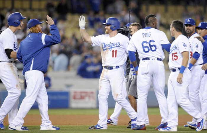 Los Angeles Dodgers third baseman Logan Forsythe (11) celebrates with third baseman Justin Turner (10) the walk off victory against the St. Louis Cardinals at Dodger Stadium. — Reuters