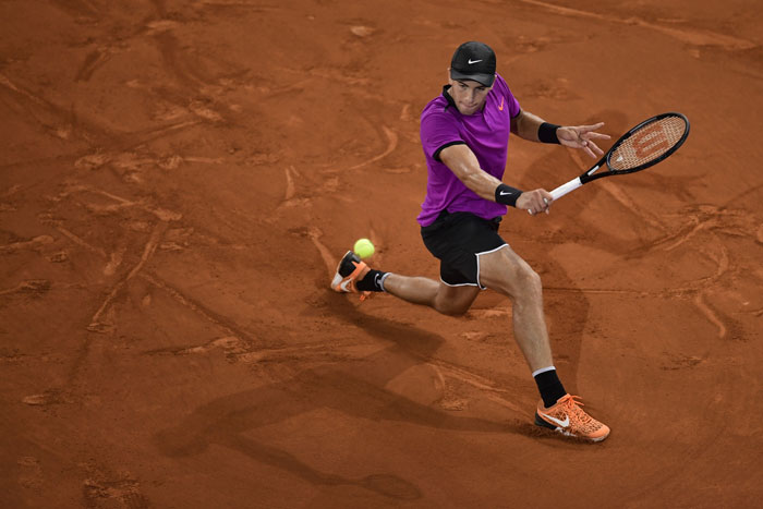 Croatian tennis player Borna Coric returns a ball to British player Andy Murray at the ATP Madrid Open in Madrid Thursday. — AFP